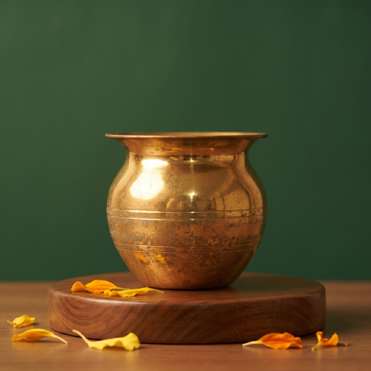 Special Sombu in straight front view on a round wooden base with scattered marigold petals against a green backdrop