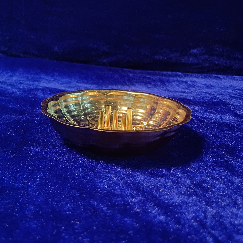 Agarbathi stand plate scalloped design slight side angle view placed on blue velvet for incense pooja