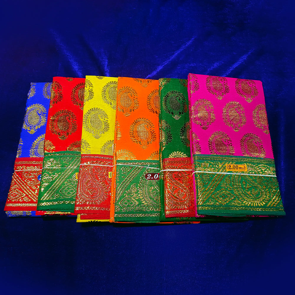 Six amman sarees in blue, red, yellow, orange, green and rose with gold zari prints, stacked in a top-down angle view on a blue velvet surface