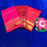 Top view of three amman saree 5mtr temple border in rose, meroon, and red with gold zari border on blue surface