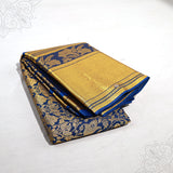 Blue amman saree with big gold jacquard floral design folded neatly side angle view for pooja and special occasions