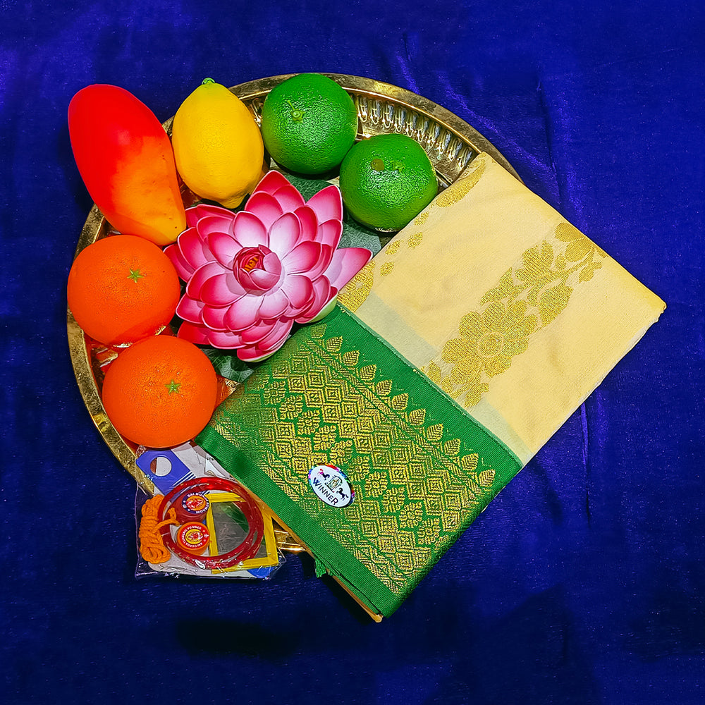 Top view of green and sandal amman saree big kota in a gold plate with fruits and lotus flower on blue surface