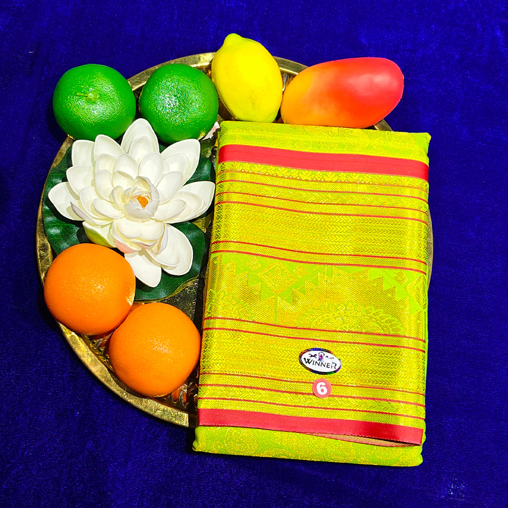 Top view of light yellow amman saree kottanji in a gold plate with fruits and lotus flower on blue surface