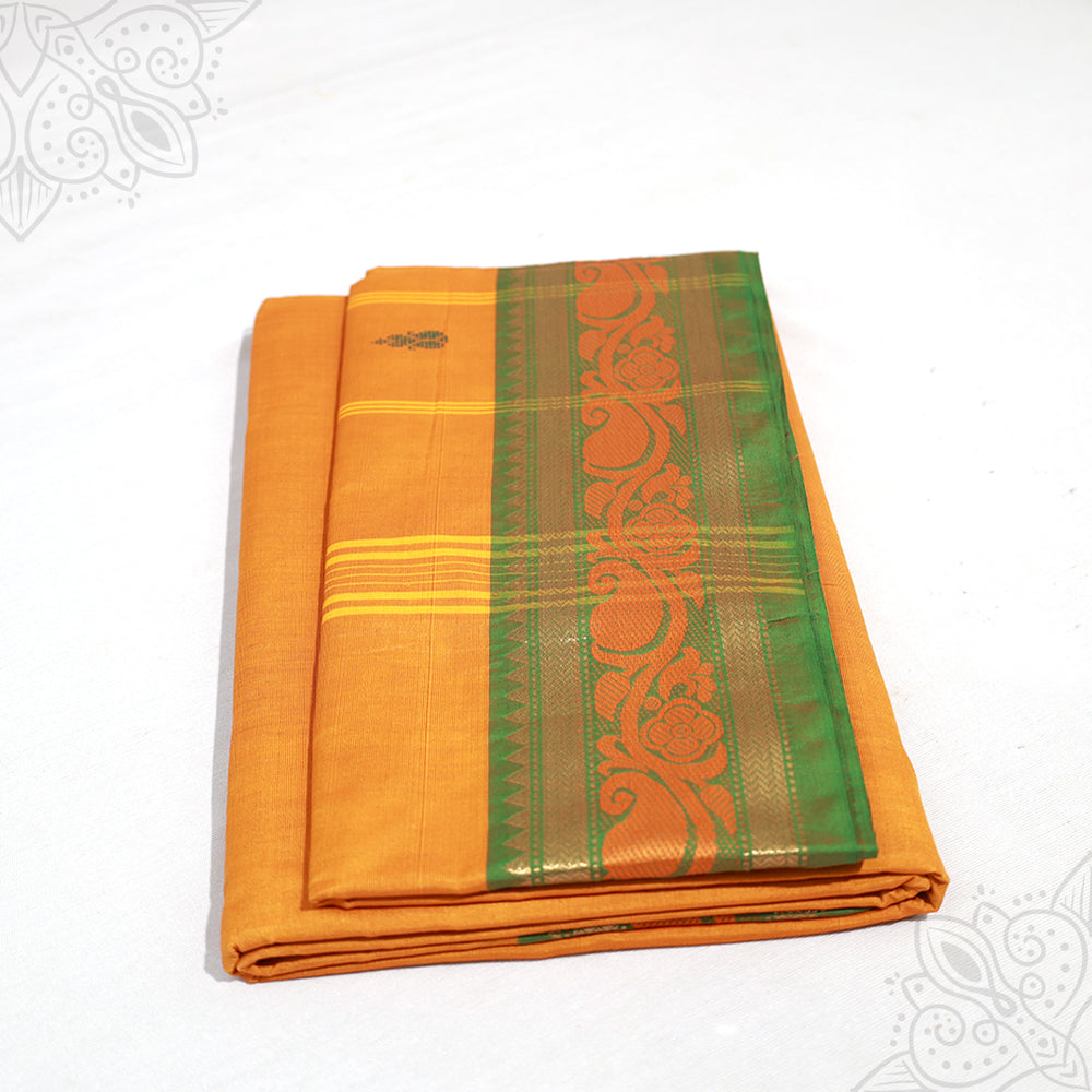 Yellow amman saree pure cotton with green and gold medium border folded neatly side angle view for daily pooja wear