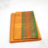 Yellow amman saree pure cotton with green and gold medium border folded neatly side angle view for daily pooja wear