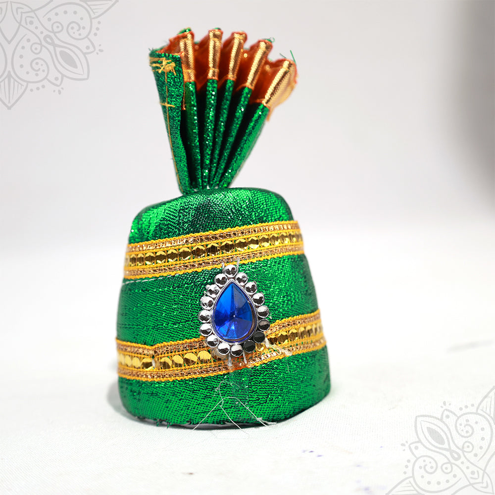 Green cloth turban with blue stone design and golden border straight front view for deity decoration