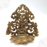 Fancy Lakshmi frame with six-faced vilakku seated on a lotus with ornate floral prabhavali in a straight front view against a white backdrop