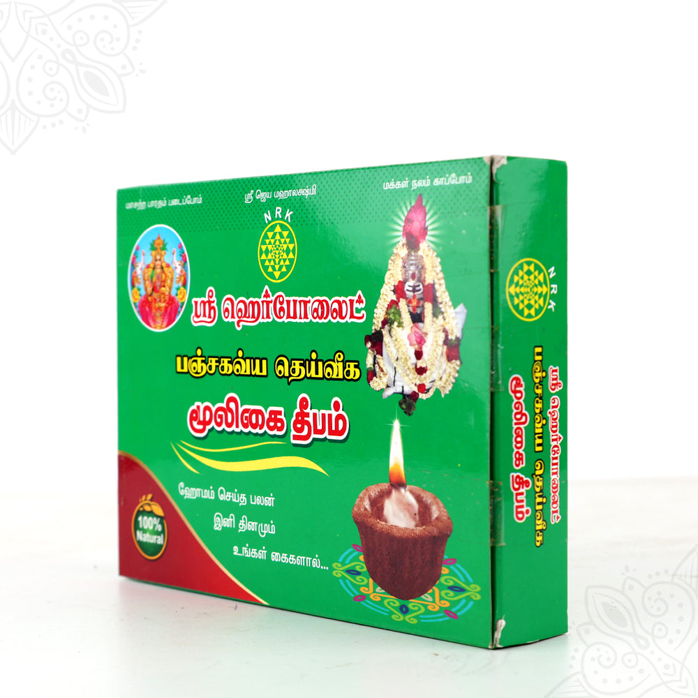 Herbolite mooligai deepam green box slight right side angle view showing lit lamp for daily home pooja