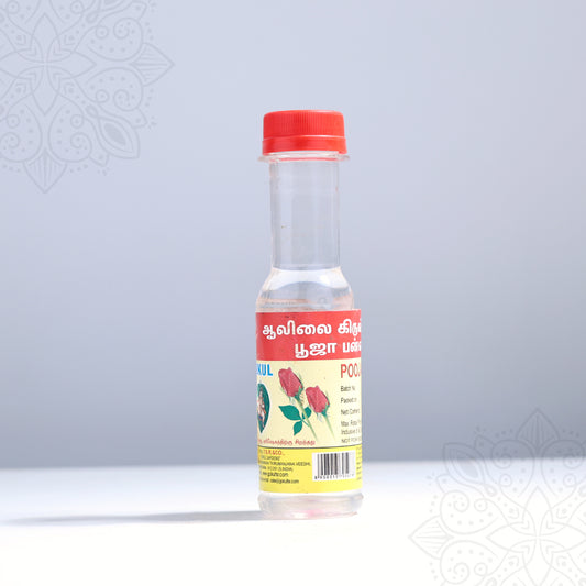 Rose water puja bottle in a slight right side view showing Tamil label with rose print and red cap against a grey background