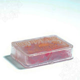 Surya brand saffron puja clear box in a low angle side view showing the box thickness and red saffron strands visible through the sides