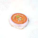 Vel senthuram paste tin top angled view showing sacred red tilak paste container closely with label