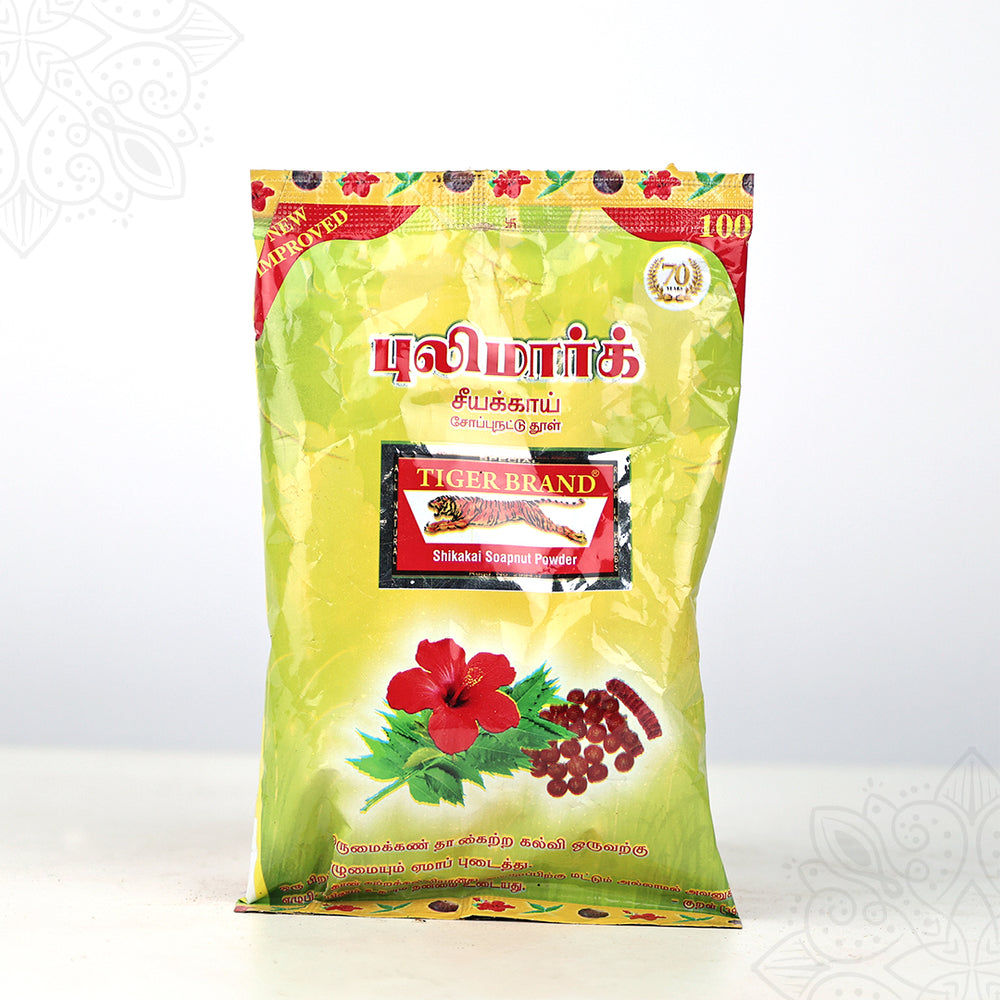 Tiger Brand shikakai soapnut powder green pack with hibiscus image shown in straight front view against white backdrop.