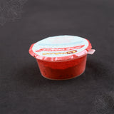 Subamangalam senthuram powder pack slight top angle view showing bright red powder inside