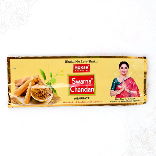 Top view of Moksh Swarna Chandan agarbatti pack with sandalwood print on gold foil pack on white surface