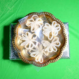 Four thamarai thandu thiri wicks in flower shape placed in urli plate top view for pooja rituals