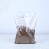Front view of thirtha parimalam powder packed in a clear plastic bag on white surface