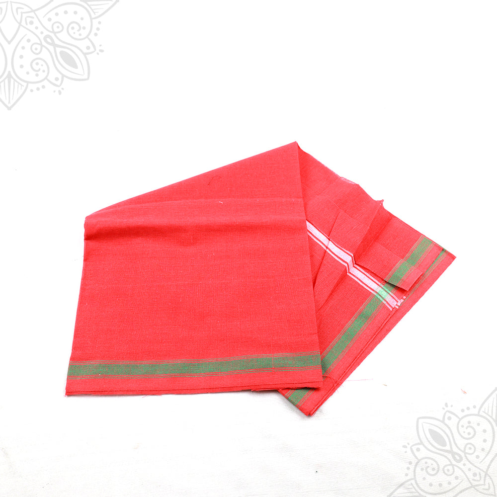 Slight top angle view of red thundu chithadai with green and silver stripe border folded on white surface