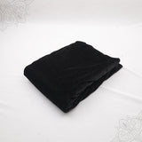 Black velvet cloth 1 meter folded neatly on white background top angle view for pooja decoration