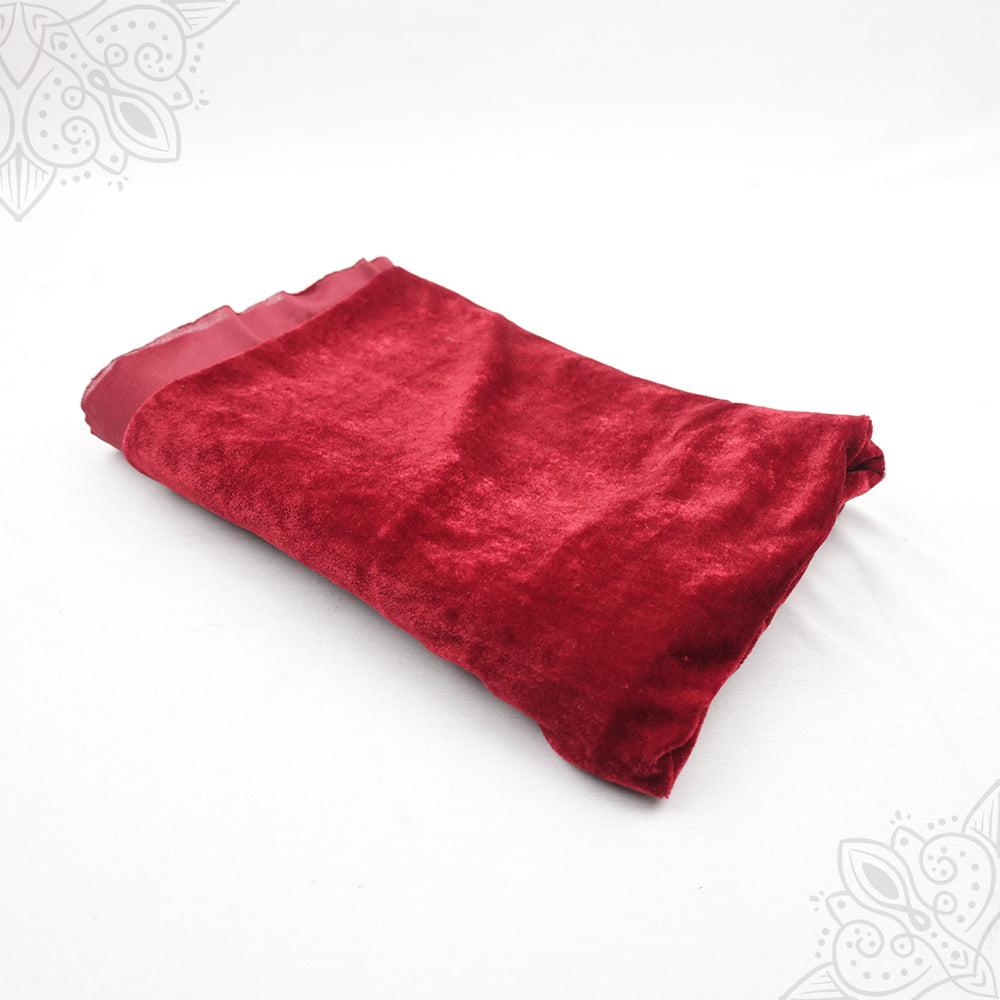 Dark red velvet cloth 1 meter folded neatly on white background top angle view for pooja decoration