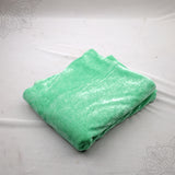 Light green velvet cloth 1 meter folded neatly on white background straight top angle view for pooja decoration