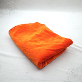 Orange velvet cloth 1 meter folded neatly on white background top angle view for pooja decoration
