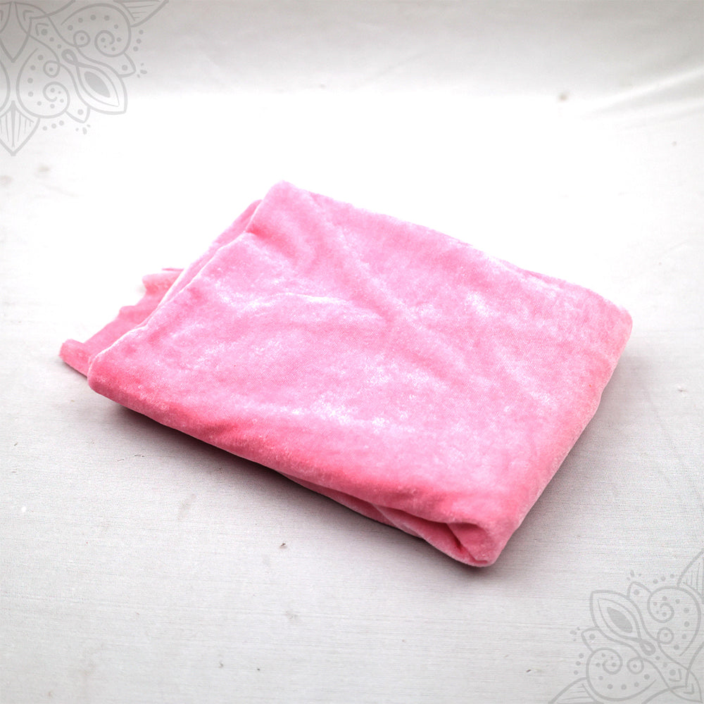 Pink velvet cloth 1 meter folded neatly on white background top angle view for pooja decoration