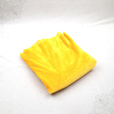 Yellow velvet cloth 1 meter folded neatly on white background straight top angle view for pooja decoration