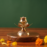 Brass Agarbatti Stand Dhoop Dani Lotus Design in front view with lotus petal base and engraved pedestal with orange petals on wooden plate.