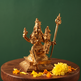 Sorna Aagashabairavar on the left side angle, seated with Parvati holding a trishul with yellow flowers and petals on a wooden plate.