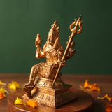 Sorna Aagashabairavar, on the right side angle, seated with Parvati holding trishul with yellow and orange petals on a wooden plate.