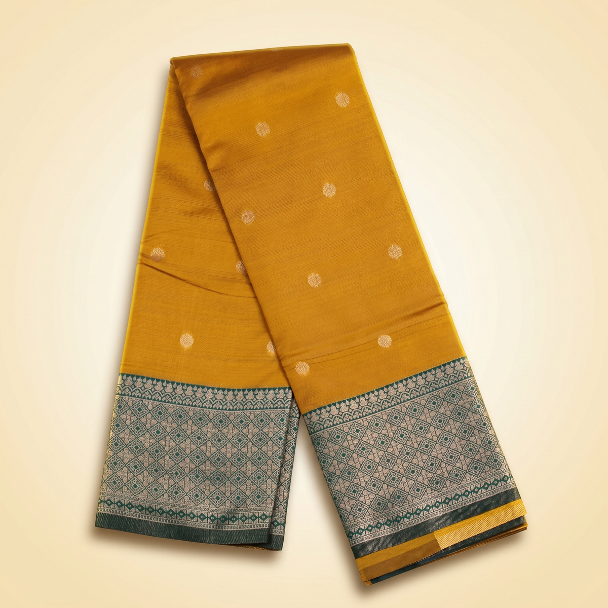 Amman soft silk saree 6 inch border in mustard with small motifs and green woven border, draped straight front view.