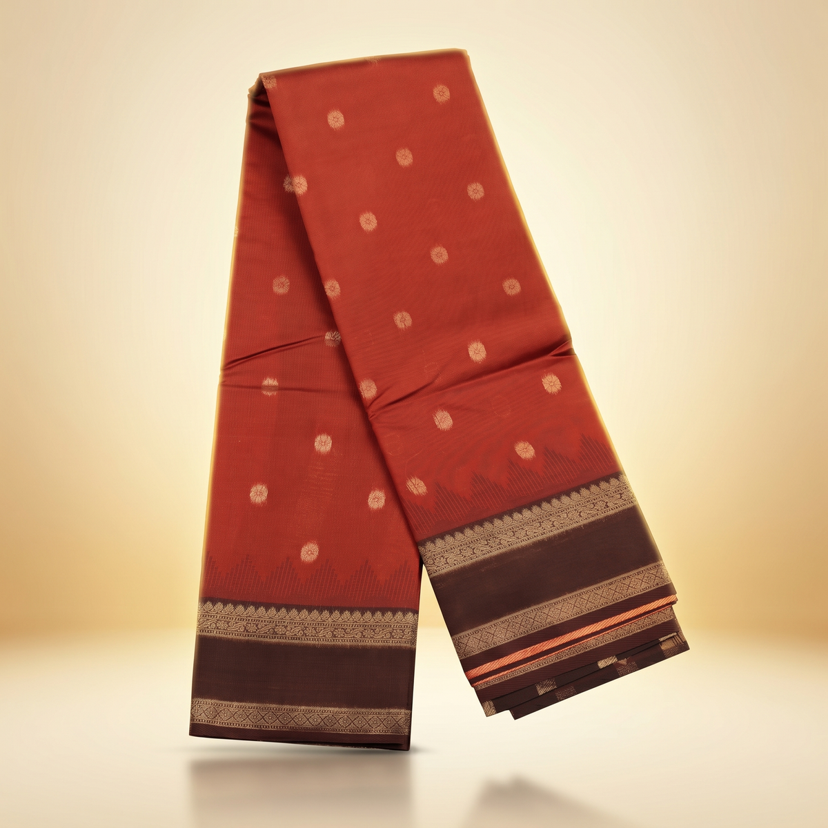 Amman soft silk saree temple border in rust orange with small motifs and brown zari temple border, draped straight front view.