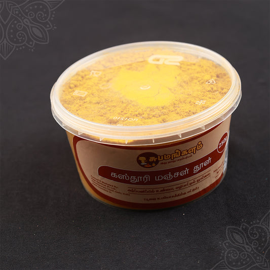 Kasturi Manjal powder tub in slight right side angle view showing the open yellow powder and label for daily pooja use
