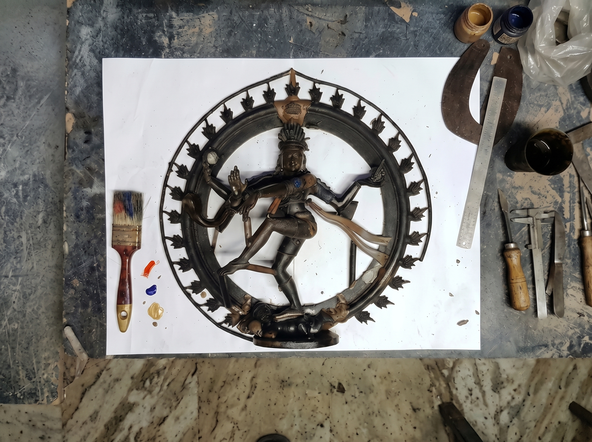 Hand-sculpting intricate mudras, jewelry, and sacred symbolic detailing