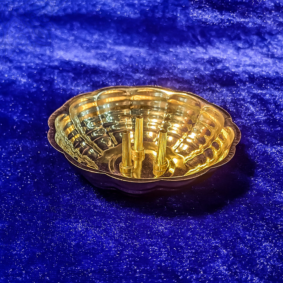 Agarbathi stand plate with shell shape design top angle view kept on blue cloth for pooja incense use