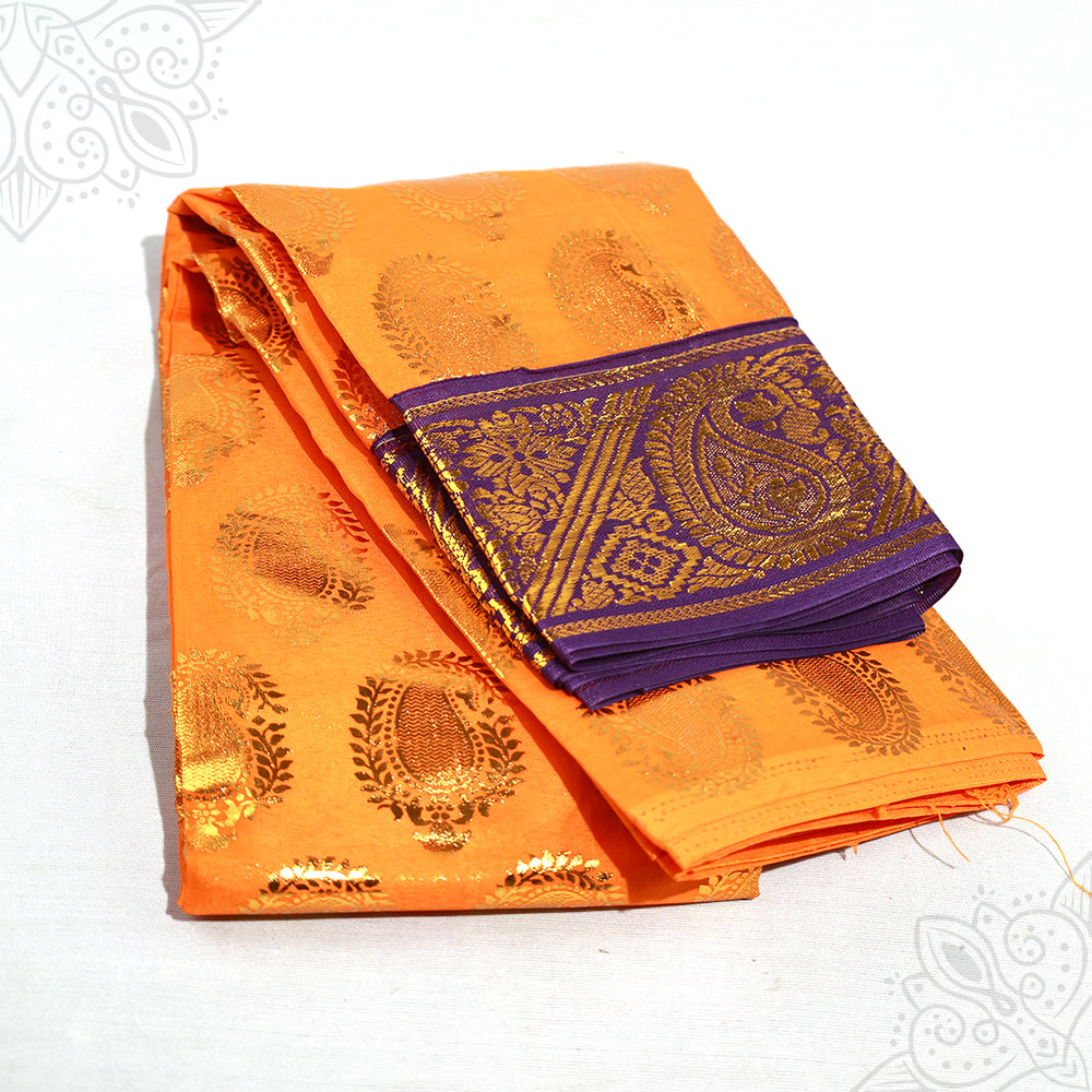 Dark Yellow Amman saree 3mtr with purple gold zari border and peacock design shown folded in slight top angled view against white surface.
