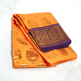 Dark Yellow Amman saree 3mtr with purple gold zari border and peacock design shown folded in slight top angled view against white surface.
