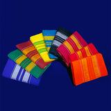 Top view of multiple amman saree 9 gajan folded in assorted colors with stripe border arranged on blue surface
