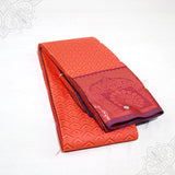 Amman saree embose orange-red with peacock motif border folded view for goddess idol decoration