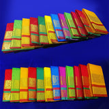 Top view of 24 amman saree jacquard folded in assorted colors with gold zari print on blue surface
