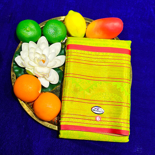 Top view of light yellow amman saree kottanji in a gold plate with fruits and lotus flower on blue surface
