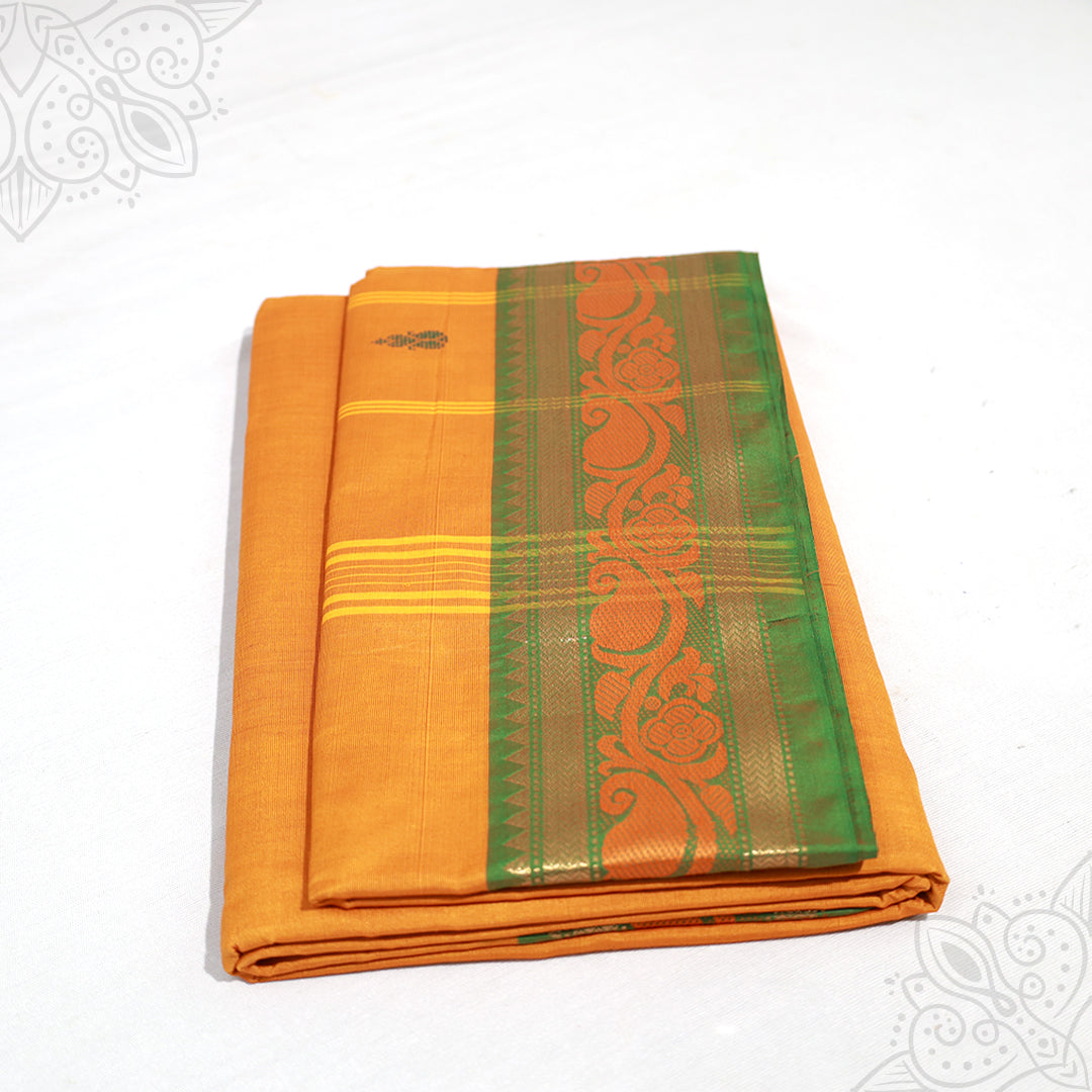 Yellow amman saree pure cotton with green and gold medium border folded neatly side angle view for daily pooja wear