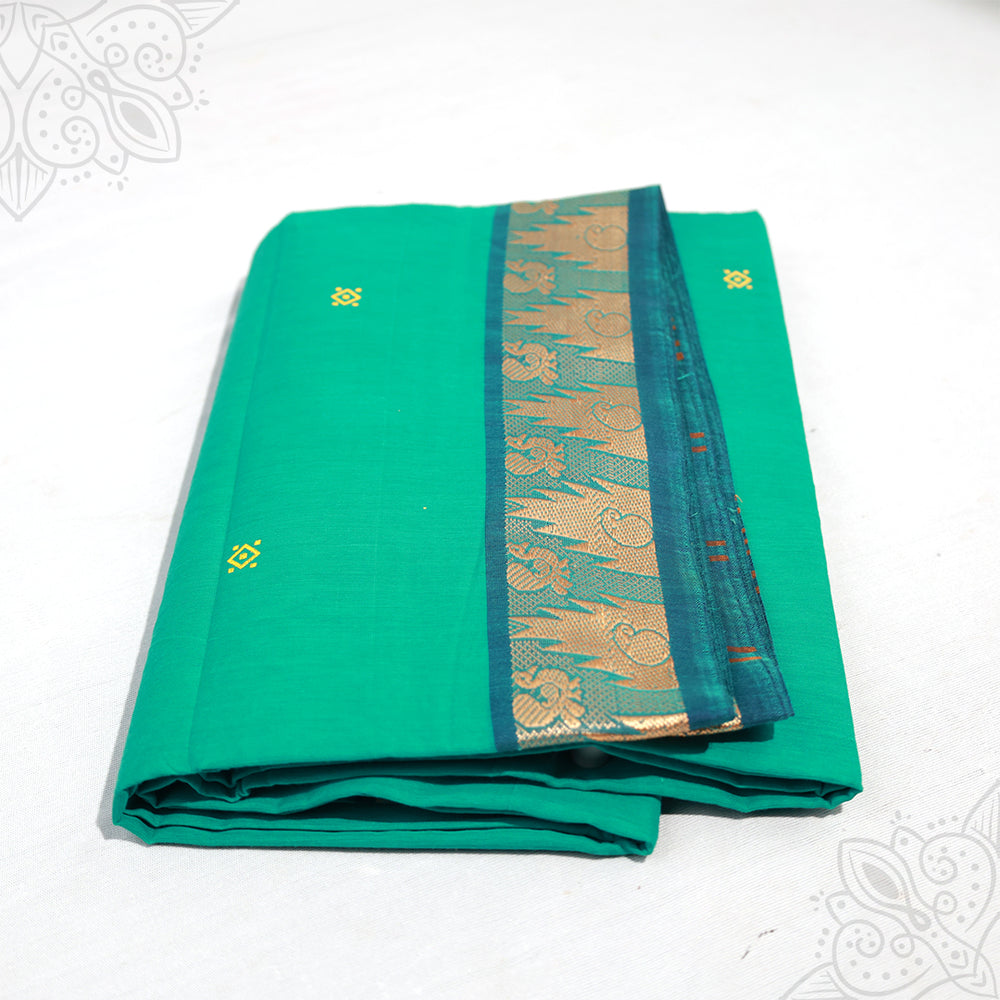 Green pure cotton amman saree with peacock design zari border folded neatly side angle view for daily pooja wear