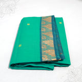 Green pure cotton amman saree with peacock design zari border folded neatly side angle view for daily pooja wear