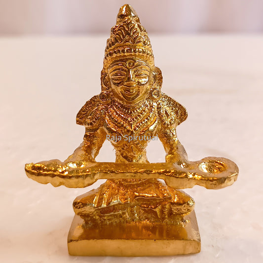 Small Annapoorani idol front facing view holding wide ladle on square pedestal plain backdrop