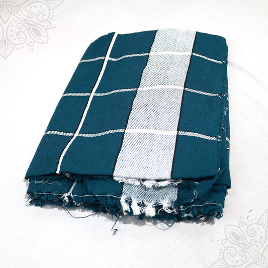 Bedsheet Meera folded in teal and white grid check cotton pattern with fringed edge on white surface, slight top-down angle view