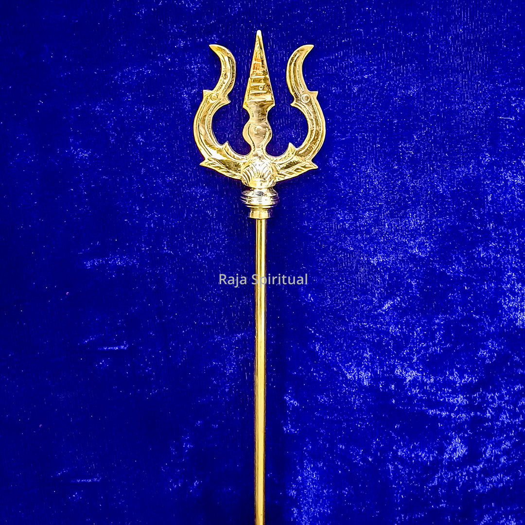Front view of brass pattai sulam 2.5ft with golden trishul head and long handle against blue surface
