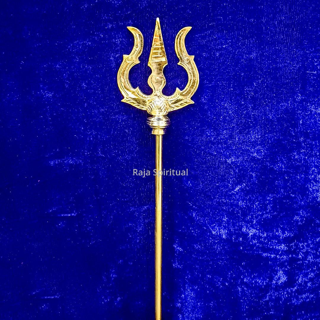 Front view of brass pattai sulam 3.5ft with golden trishul head and long handle against blue surface
