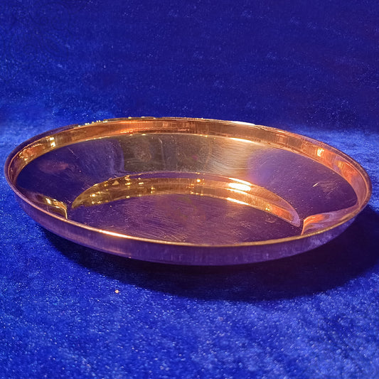 Copper Harivan plate with a raised rim and traditional design shown in a straight top view.