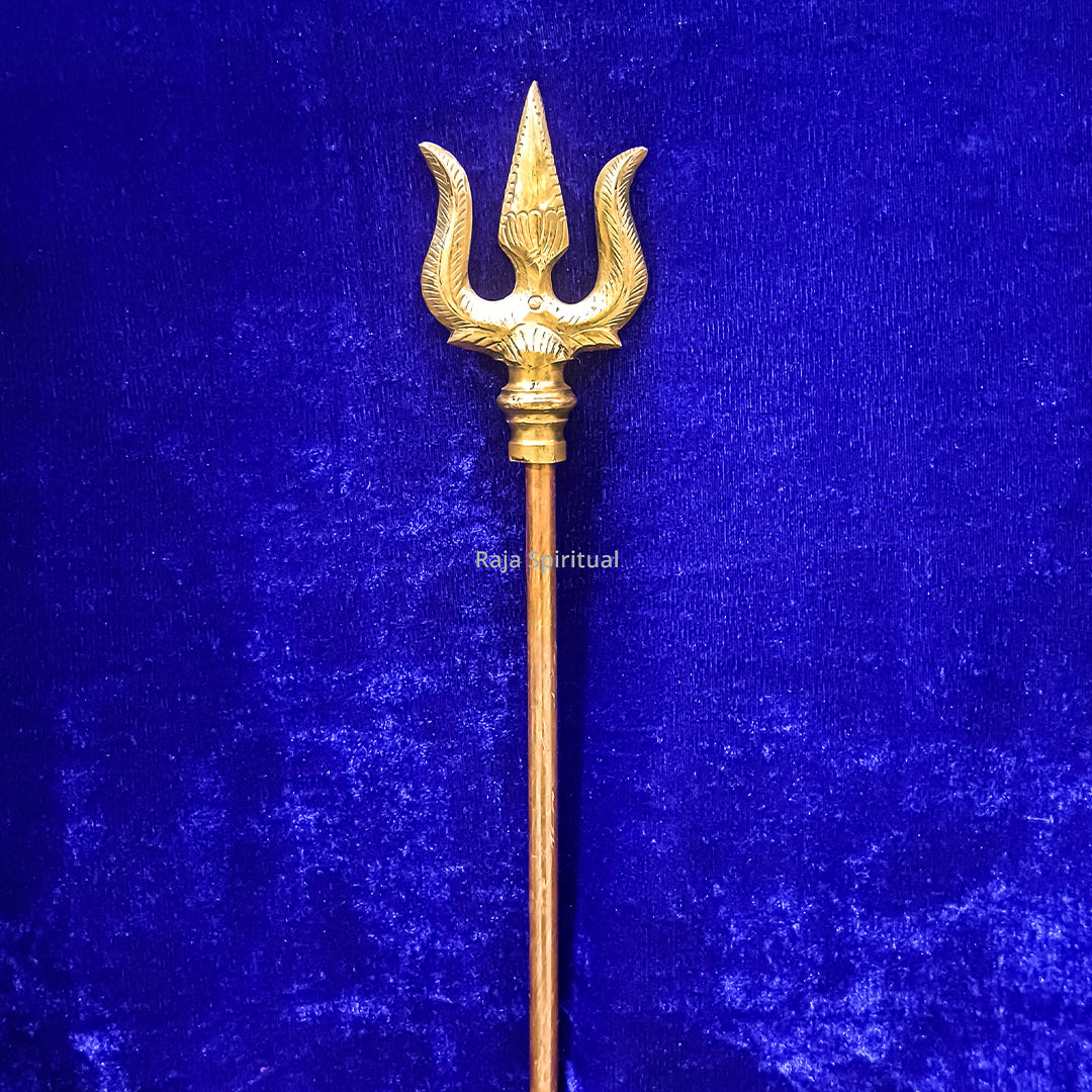 Copper pattai sulam trishul with curved prongs and long slim handle on blue velvet background, straight front view